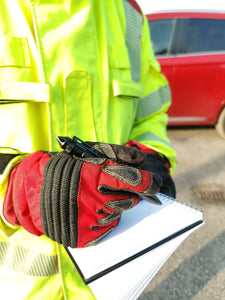 Firefighter writing with tactical pen with gloves on. 